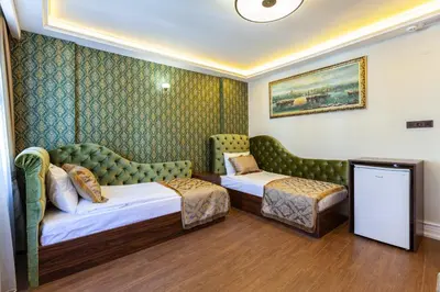 a hotel room with two beds and a couch at Rose Mansion by Otantik Suites in Istanbul