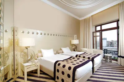 a hotel room with a large bed and a window at Taxim Hill Hotel in Istanbul