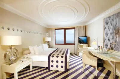 a hotel room with a large bed and a desk at Taxim Hill Hotel in Istanbul