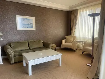 a living room with a couch and a table at EmexOtel Kocaeli in Kocaeli