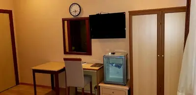 a room with a desk with a computer and a tv at EmexOtel Kocaeli in Kocaeli