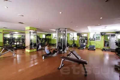a man exercising in a gym with pilates equipment at EmexOtel Kocaeli in Kocaeli