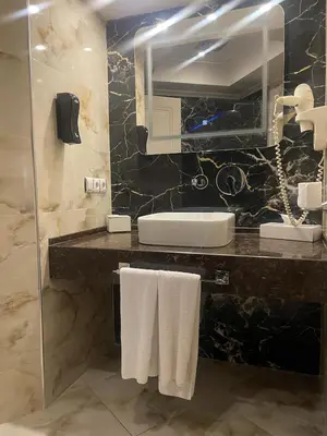a bathroom with a sink and a mirror at EmexOtel Kocaeli in Kocaeli