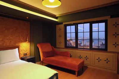 a bedroom with a bed and a chair and a window at Sublime Porte Hotel in Istanbul