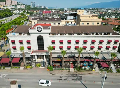 a white building with a clock on the side of it at New Balturk Hotel Izmit in Kocaeli