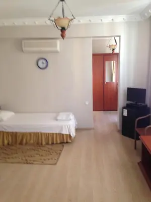 a room with a bed and a clock on the wall at Hotel Atasayan in Gebze