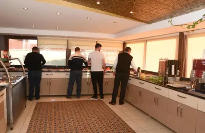 a group of men standing in a kitchen preparing food at Grand Rosa Hotel in Istanbul