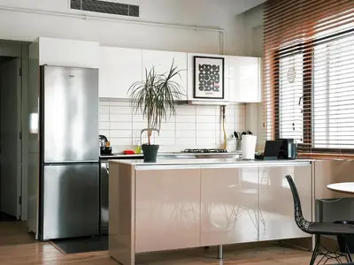 a kitchen with white cabinets and a stainless steel refrigerator at GALATA M84 in Istanbul