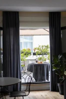a dining room with a table and a large window at GALATA M84 in Istanbul