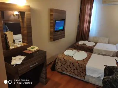 a hotel room with two beds and a mirror at Hotel Bazaar in Istanbul