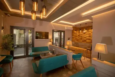a living room with green chairs and a couch at Anatolia Inn in Istanbul