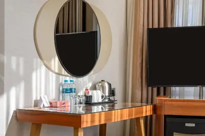 a room with a table with a mirror and a television at Four Points Flex by Sheraton Istanbul Taksim Square in Istanbul