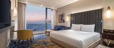 a hotel room with a bed and a desk and a window at Hilton Istanbul Bakirkoy in Istanbul