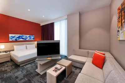 a living room with a couch and a bed at Hyatt House Gebze in Gebze