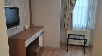 a room with a desk with a television and a chair at Hotel Süreyya in Istanbul