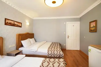 a hotel room with two beds and a door at Authentic Apartments OldCity in Istanbul