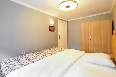 a bedroom with a white bed and a cabinet at Authentic Apartments OldCity in Istanbul