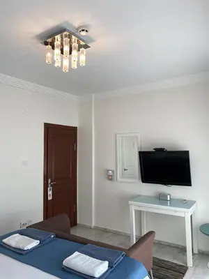 a room with a bed and a tv on the ceiling at My Kent Hotel in Istanbul