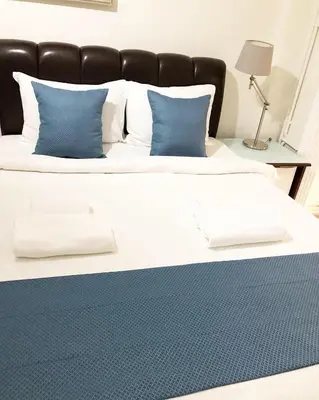 a large bed with blue and white pillows on it at My Kent Hotel in Istanbul