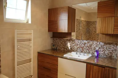 a kitchen with a sink and wooden cabinets at Damla Pansiyon in Sapanca