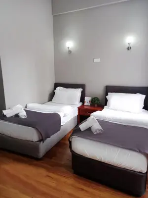 a room with two beds and a red table at Antik Ipek Suit in Istanbul