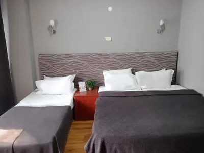 a hotel room with two beds and a red table at Antik Ipek Suit in Istanbul