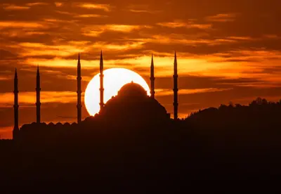 a silhouette of a mosque with a sunset in the background at Hotel Momento Golden Horn in Istanbul