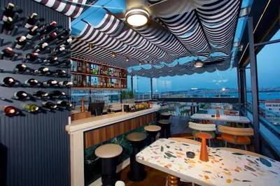 a restaurant with a bar and tables and wine bottles at Hotel Momento Golden Horn in Istanbul