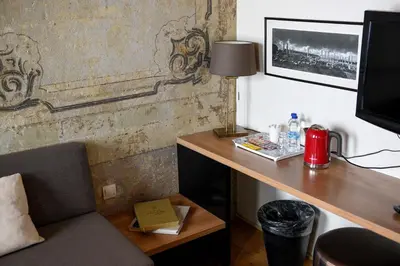 a room with a desk with a lamp and a chair at Taksim Galata Tower, Rooms Galata Historical Hotel in Istanbul