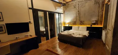 a bedroom with a bed and a flat screen tv at Taksim Galata Tower, Rooms Galata Historical Hotel in Istanbul