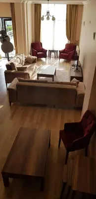 a living room with two couches and a table at Sawsana Villalari in Sapanca