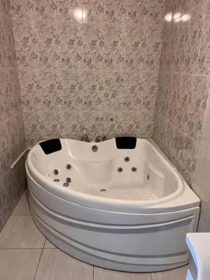 a white bath tub in a bathroom with a wall at Sawsana Villalari in Sapanca