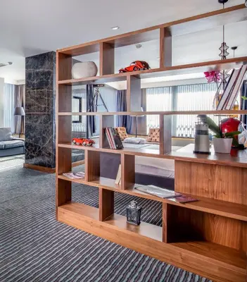 a large wooden book shelf in a living room at Volley Hotel Istanbul in Istanbul