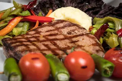 a plate of food with meat tomatoes and vegetables at Volley Hotel Istanbul in Istanbul