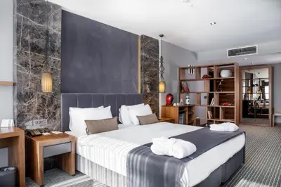 a bedroom with a large bed with white towels on it at Volley Hotel Istanbul in Istanbul