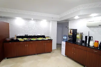 a kitchen with a counter with plates of food at Lyon Hotel İstanbul in Istanbul