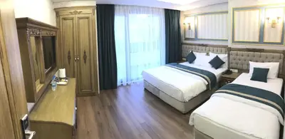 a hotel room with two beds and a window at Ahmet Efendi Konağı in Istanbul