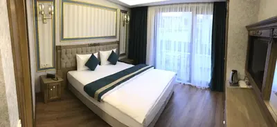 a bedroom with a large white bed and a window at Ahmet Efendi Konağı in Istanbul