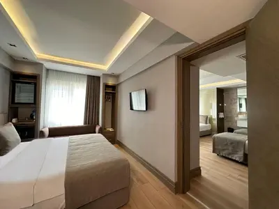a hotel room with a large bed and a mirror at AHC Grand Bazaar Hotel in Istanbul