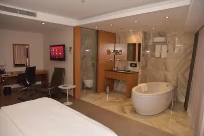 a hotel room with a bed and a bath tub at Crowne Plaza Istanbul Harbiye by IHG in Istanbul