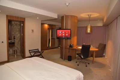 a hotel room with a bed and a desk and a television at Crowne Plaza Istanbul Harbiye by IHG in Istanbul