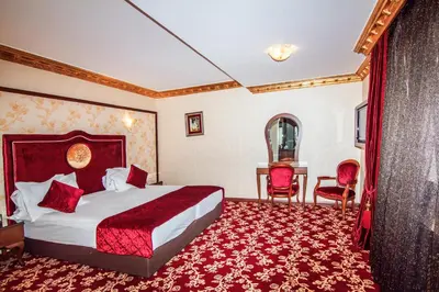 a hotel room with a bed and a table and chairs at Antea Palace Hotel & Spa in Istanbul
