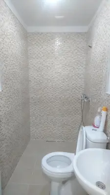 a bathroom with a white toilet and a sink at Kumbaz Pansiyon in Sapanca