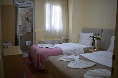 two beds in a hotel room with towels on them at Sur Istanbul Hotel in Istanbul