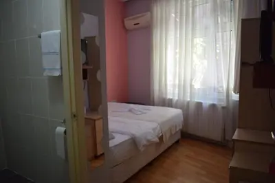 a small bedroom with a bed and a window at Sur Istanbul Hotel in Istanbul