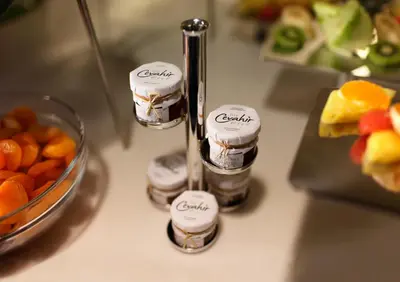 a group of candles on a counter with a bowl of fruit at Biz Cevahir Hotel Sultanahmet in Istanbul