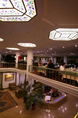 a lobby of a hotel with people at a bar at Istanbul Royal Hotel in Istanbul