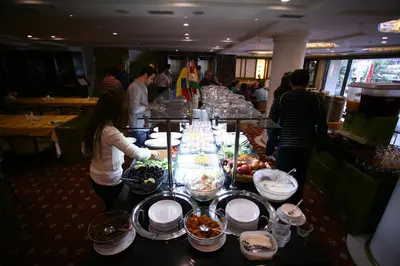 a buffet line with plates of food on a table at Istanbul Royal Hotel in Istanbul