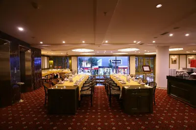a dining room with tables and chairs in a restaurant at Istanbul Royal Hotel in Istanbul