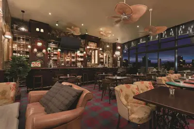 a restaurant with a bar with tables and chairs at TRYP by Wyndham Istanbul Basın Ekspres in Istanbul